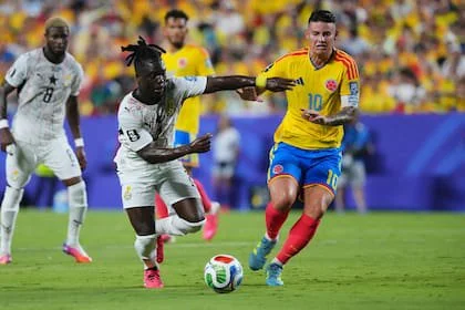 Ghana's Alidu Seidu (2) and Colombia's James Rodriguez battle for the ball during the World Cup round of 32 soccer match in Kansas City, Mo., Friday, July 3, 2026. (AP Photo/Ed Zurga)